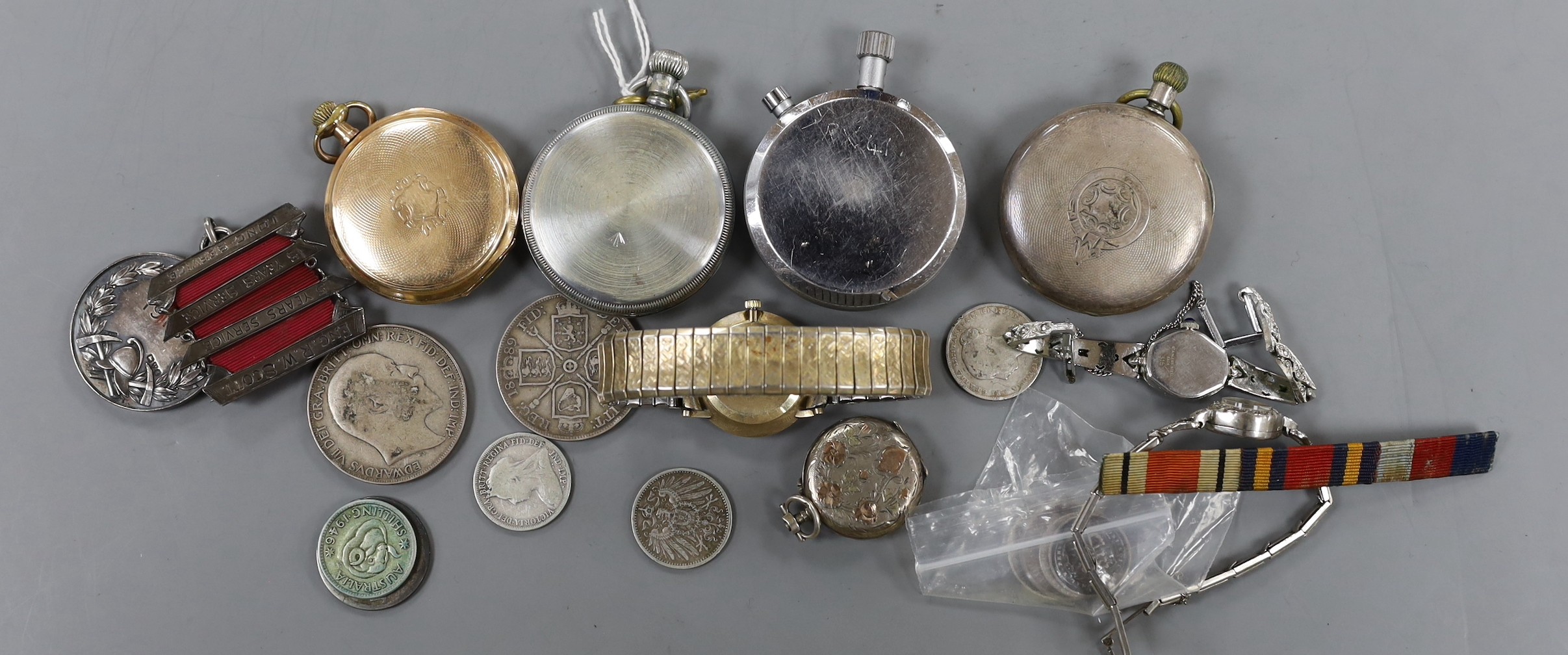 Two Waltham pocket watches including black dial military, a stopwatch, Longines Cosmo gold plated watch, lady's watch minor coins and a Fire Brigade medal.